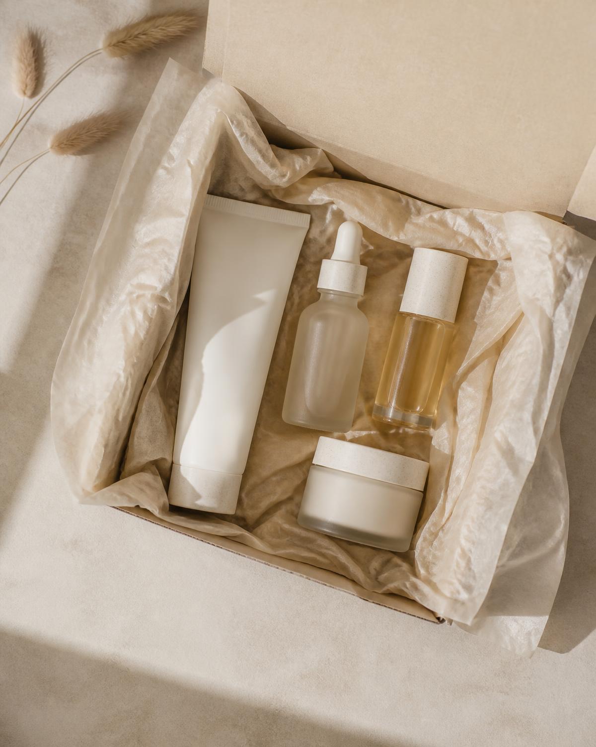 Beauty PR gift box with skincare bottles wrapped in tissue paper